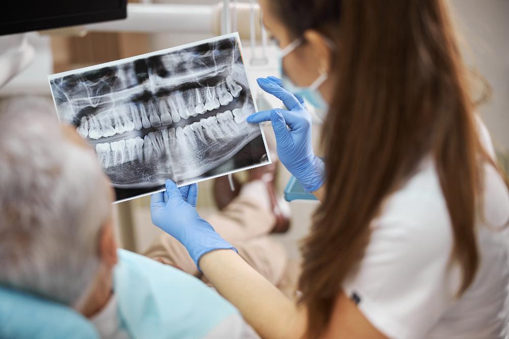 dentist showing patient a dental xray